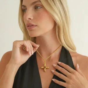 18k gold cross necklace worn on model upper body side view blonde woman black halter top