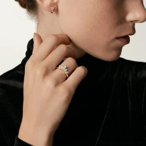 Close-up side view of 18K Gold Crown Diamond Ring worn on finger with sparkling gem details