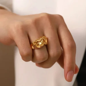 Adjustable 18K gold open cuff ring worn on middle finger close-up hand perspective showing warm gold finish
