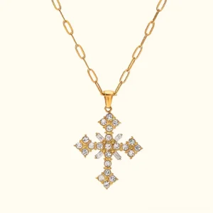 18K gold crystal cross necklace front flat lay view featuring sparkling cubic zirconia pendant on paperclip chain against neutral background