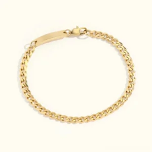 18K gold curb chain ID bracelet flat lay polished finish white background