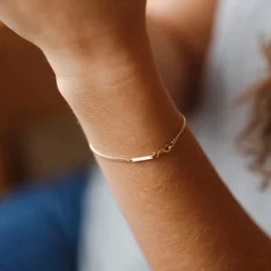 18K gold curb chain ID bracelet on wrist close-up worn model fit