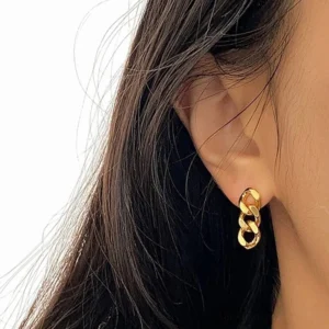 chunky gold curb chain stud earrings worn on ear side close-up view female model
