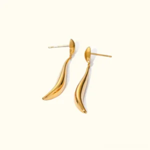18K gold dangle drop earrings with twisted elongated design, flat lay studio shot on neutral background showing high-polish finish