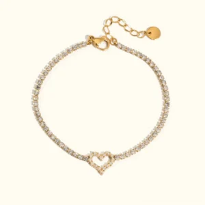 18K gold diamond heart tennis bracelet flat lay showcase on neutral background showing full adjustable length and crystal pavé heart charm