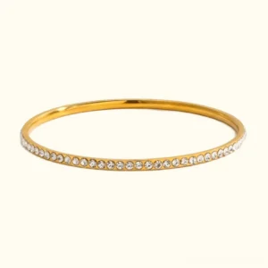 18K gold diamond pavé bangle bracelet - front view flat lay featuring polished gold band with micro-pavé crystal setting on neutral background
