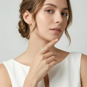 Minimalist gold diamond stackable ring worn on female model index finger elegant style