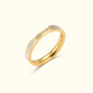 18K gold diamond simulant ring with white enamel accents, polished gold band with cubic zirconia stones, product studio photography