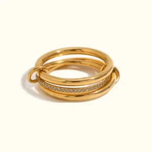 18K gold diamond stack ring set flat lay - multiple stackable rings with pavé crystals and twisted bands in yellow gold
