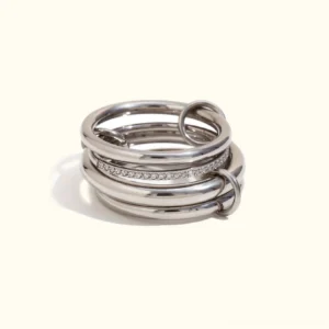 18K gold diamond stackable ring set flat lay top-down view polished silver bands with pavé crystal details