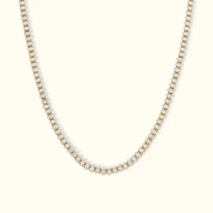 18K gold diamond tennis necklace with oval-cut diamond simulants in pavé setting, flat lay overhead view on beige background
