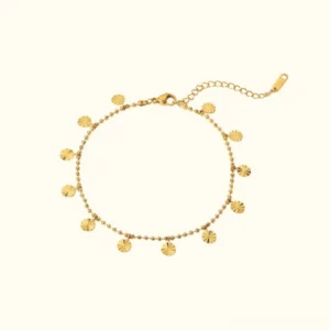 18K gold disc charm anklet flat lay overhead view showing delicate beaded chain with engraved disc charms and adjustable extender
