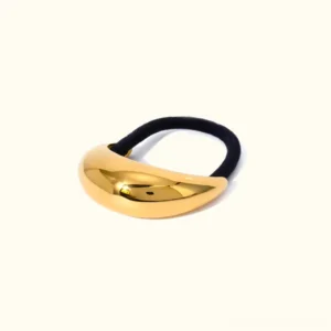 18K gold dome ponytail cuff flat lay, front view showing crescent shape and polished gold finish with elastic band