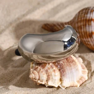 Gunmetal gray dome hair cuff with conch shell beach styling, oblique side angle view