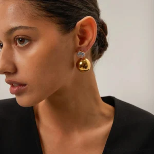 woman wearing 18K gold dome stud earrings on ear, side profile portrait showing daily wear styling and sparkle effect