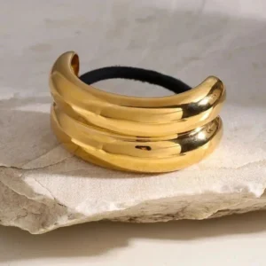 Luxury 18K gold plated hair cuff side angle view showing shiny dual layered curved design with black hair band