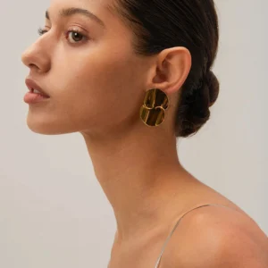 18K gold double disc earrings worn on model left ear profile close-up studio shot