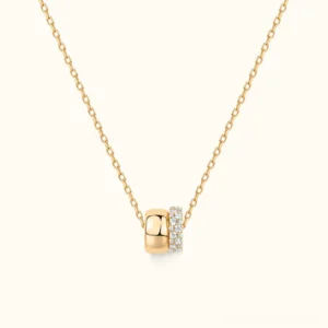 18K yellow gold dual-ring pendant necklace flat lay, polished and pavé crystal rings on delicate chain, luxury minimalist jewelry design