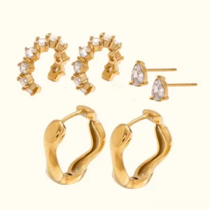 Complete 18k gold earring set flat lay studio shot showing all three earring styles cubic zirconia diamond simulants