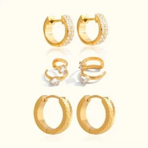 Complete 18K gold earring bundle flat lay showing all three pieces - textured hoops, diamond hoops, and ear cuff on neutral background