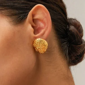 Textured 18K gold stud earrings worn on ear close-up showing snug fit and polished finish