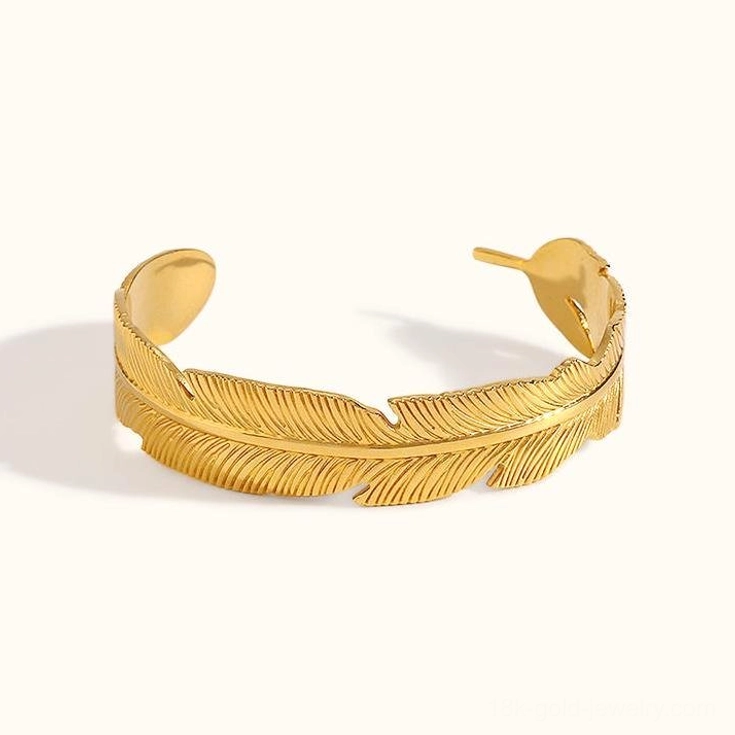 18K gold feather open cuff bracelet front view flat lay on white background with detailed feather texture carving