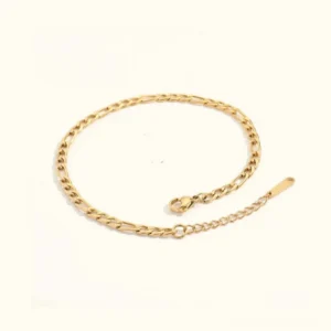 18K gold figaro chain anklet flat lay product view on white background showing adjustable clasp and polished gold finish