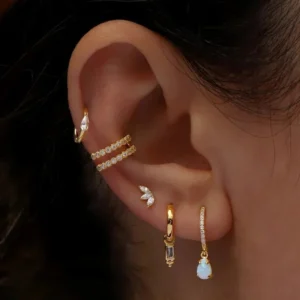 wearing 18K gold plated flat back stud earrings on cartilage helix piercing close-up side view on ear