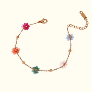 18K gold floral charm bracelet flat lay with multicolor resin flower charms on gold-toned chain, waterproof design