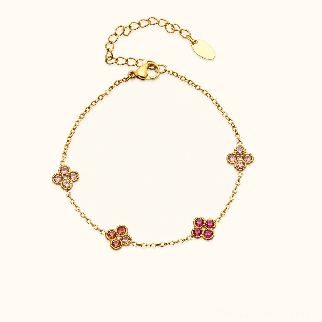 18K pink gold four-leaf clover bracelet with emerald green gemstone charms, studio flat lay view