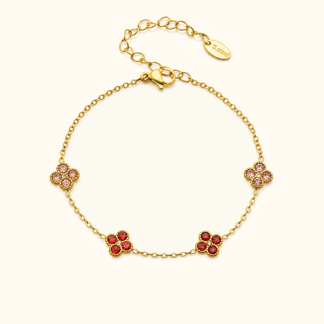 18K red gold four-leaf clover bracelet with ruby gemstone charms, studio flat lay presentation
