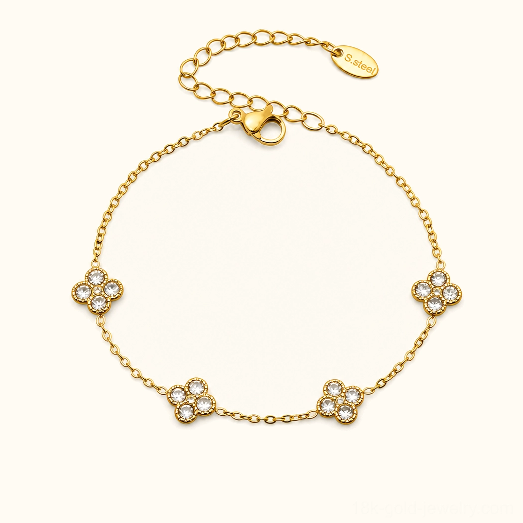 18K yellow gold four-leaf clover bracelet with diamond simulant gemstones, flat lay studio photography