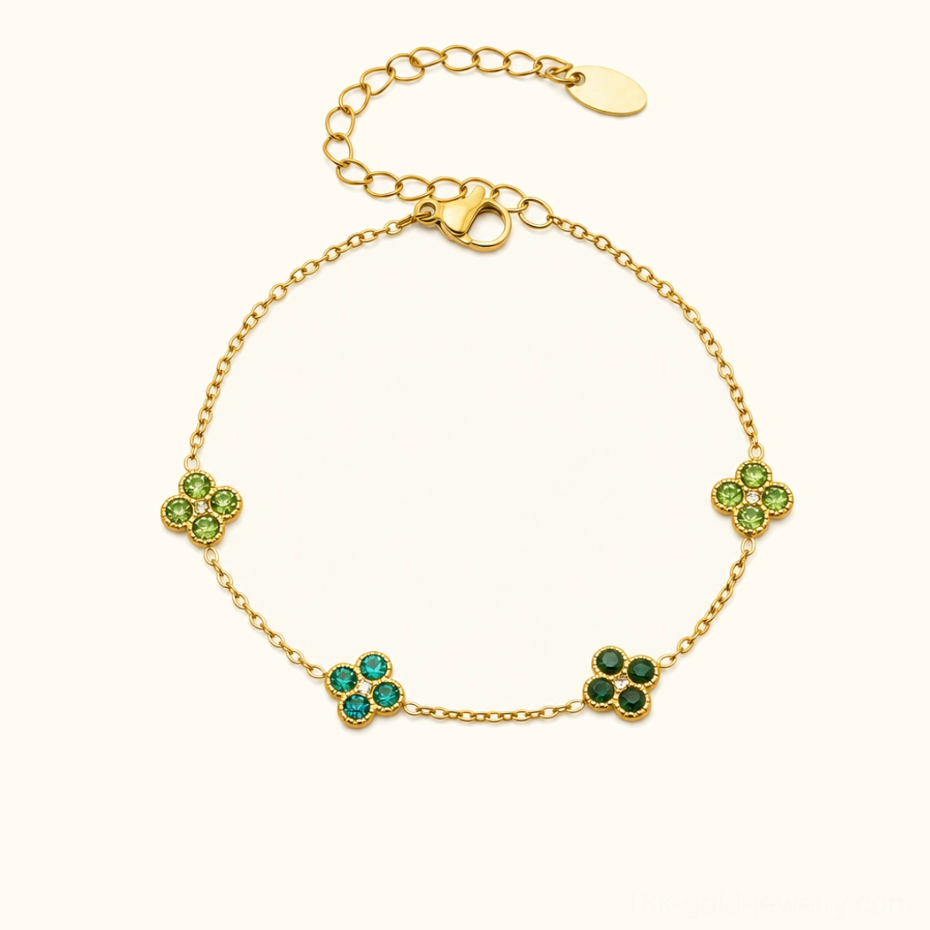 18K yellow gold four-leaf clover bracelet with emerald green gemstone charms, studio photography