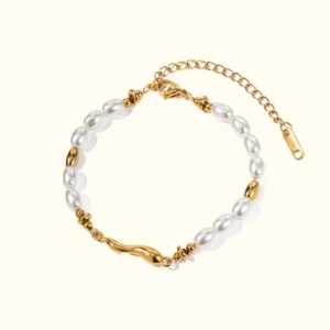 18K gold freshwater pearl bracelet flat lay top view with oval rice pearls and twisted gold accents on light background