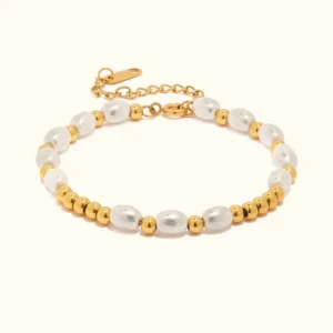 18k gold freshwater pearl bracelet top view flat lay showing white lustrous pearls paired with polished gold beads and adjustable extender chain