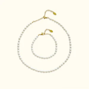 18K gold freshwater pearl choker and bracelet bundle set flat lay product display on neutral background