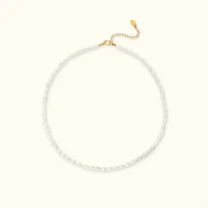 18K gold freshwater pearl choker flat lay top view showing delicate oval pearls and adjustable gold chain on white background