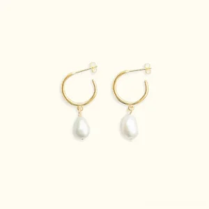 18K gold freshwater pearl drop earrings with baroque pearls and diamond simulants on neutral background