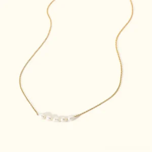 18K gold freshwater pearl necklace minimalist overhead flat lay view white pearls thin gold chain