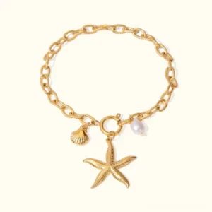18K gold freshwater pearl ocean charm bracelet with starfish shell and pearl charms on textured cable chain flat lay