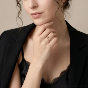 Woman wearing stackable thin 18K gold rings with clear cubic zirconia accents on hands