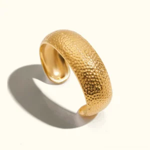 18K gold hammered open cuff bracelet with textured dimpled finish front view on neutral background