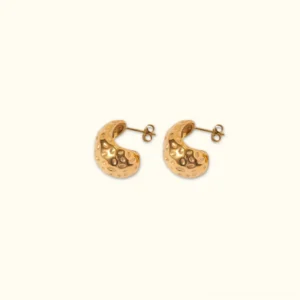 18K gold hammered C-hoop stud earrings with textured surface - front flat lay view on neutral background