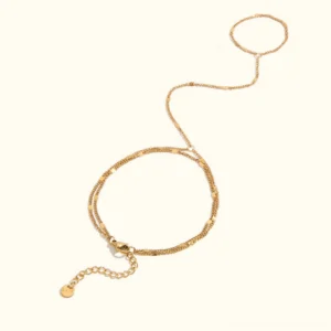 18K gold hand chain bracelet flat lay on white background - adjustable finger to wrist jewelry with delicate chain design
