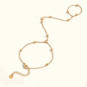 18K gold hand chain bracelet with heart cubic zirconia charm, adjustable finger chain flat lay on white background, detailed product view
