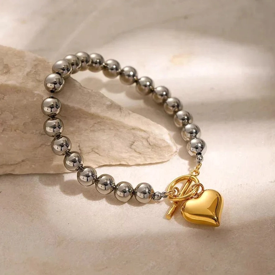 18K gold heart bracelet side flat lay minimalist stone display OT toggle clasp visible