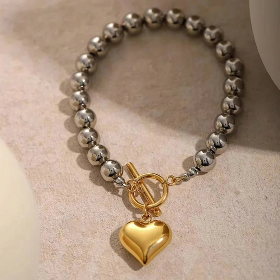 18K gold heart charm bracelet top down overhead view complete length puffy heart pendant