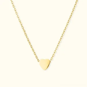 18K gold heart pendant necklace flat lay front view on off-white background, delicate thin chain with small smooth heart charm