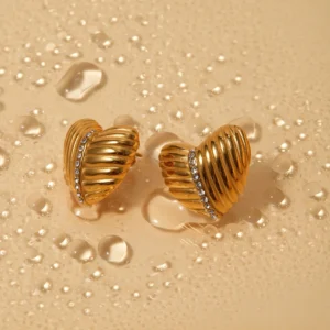 18K gold heart earrings with CZ accent stripe top-down view water-resistant durability showcase