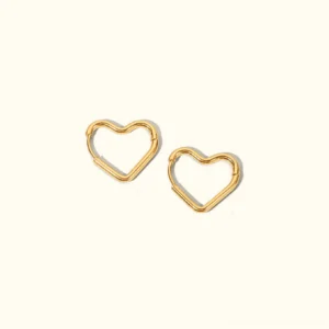 18K gold heart hoop earrings flat lay top-down view on plain white background showing hollow heart-shaped design